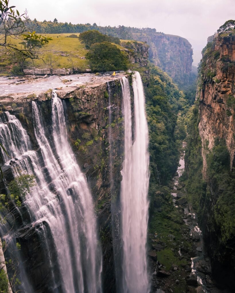 Dramatic view of a serene waterfall in Mpumalanga, surrounded by lush greenery.